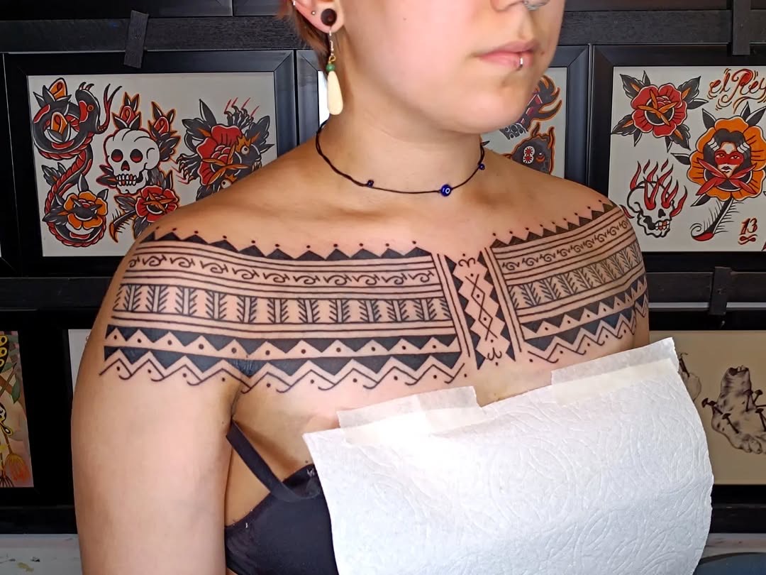Wide angle view of Filipino tribal chest tattoo session at Good Hand Tattoo
